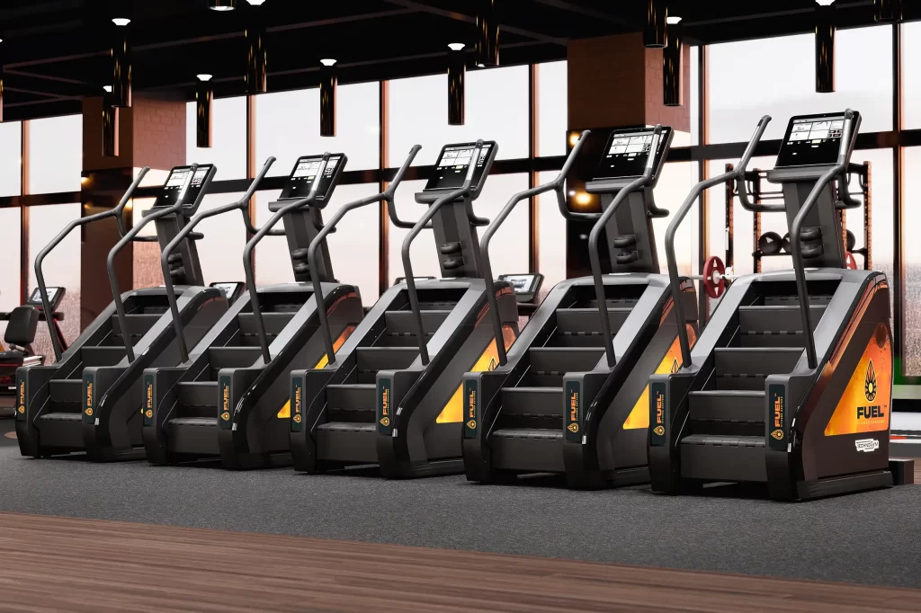 A row of branded stair climber machines in a modern wellness center setting.