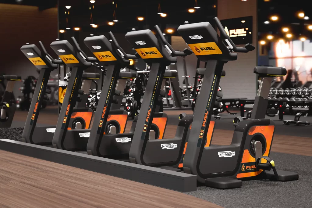 Multiple branded fitness machines, including cardio and strength equipment, in a professional gym setting.