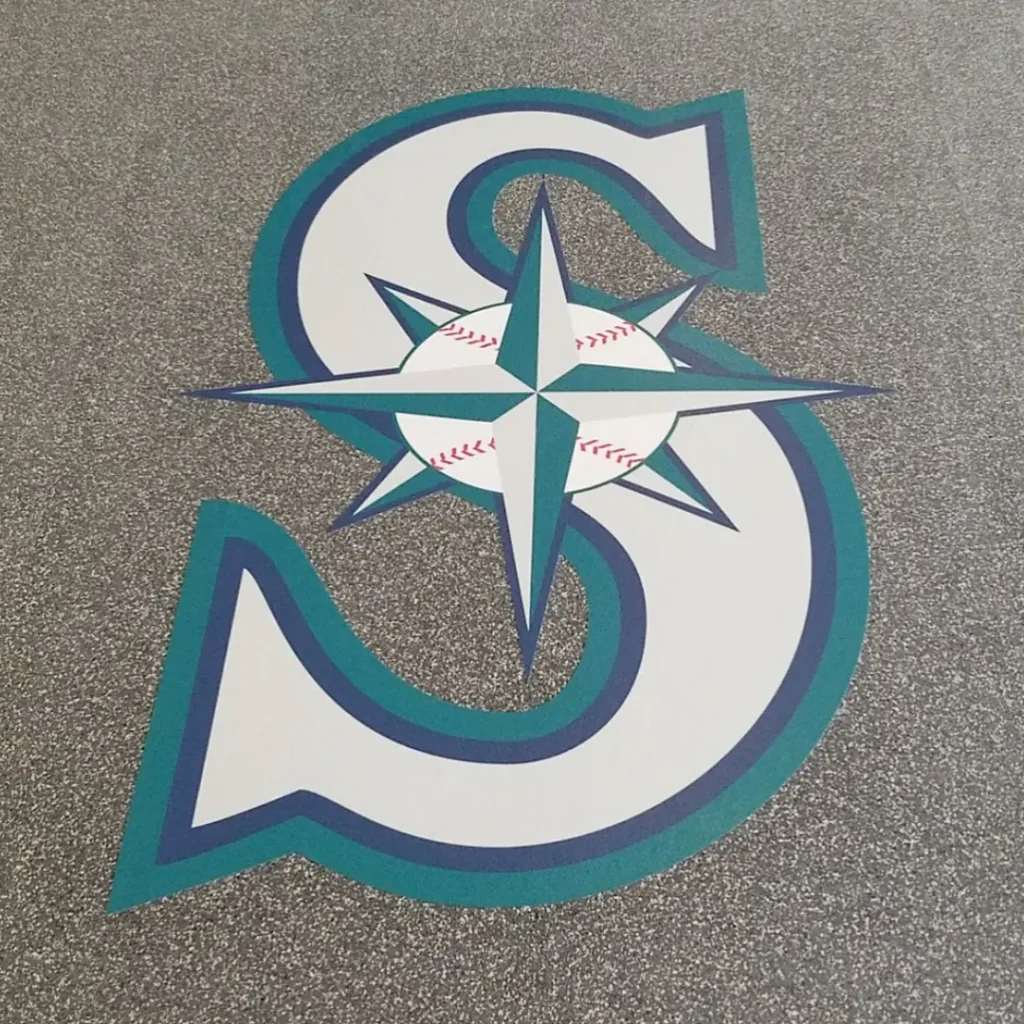 Close-up of a Seattle Mariners mascot floor logo created with our engineered graphics technology and installed on black-and-white speckled rubber flooring.