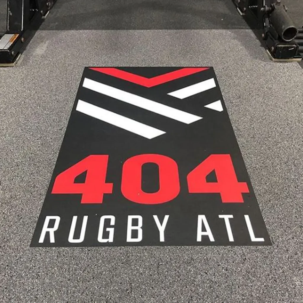 404 Rugby ATL engineered floor graphic installed on Steel Appeal rubber flooring with small portions of rack feet visible in the upper corners.
